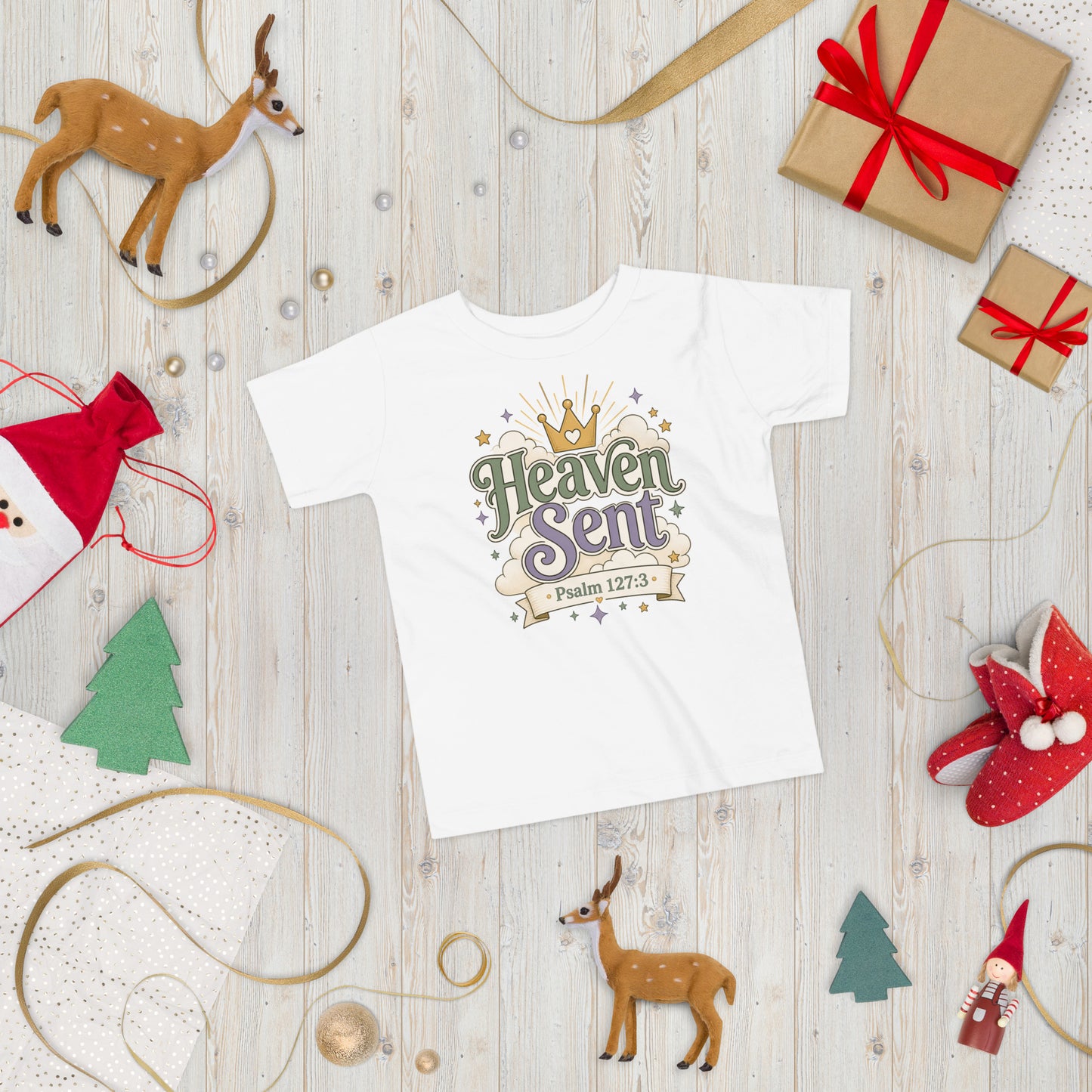Christian toddler shirt design reading Heaven Sent with Psalm 127:3, featuring a crown, clouds, stars, and soft green, lavender, cream, and gold colors.