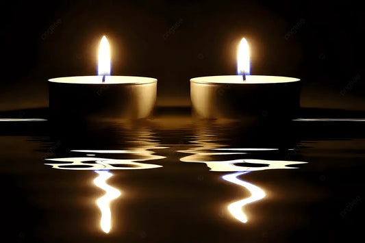 Two candles burning in darkness symbolizing Hanukkah Day 2, continued obedience, and God’s light multiplying through endurance and faith