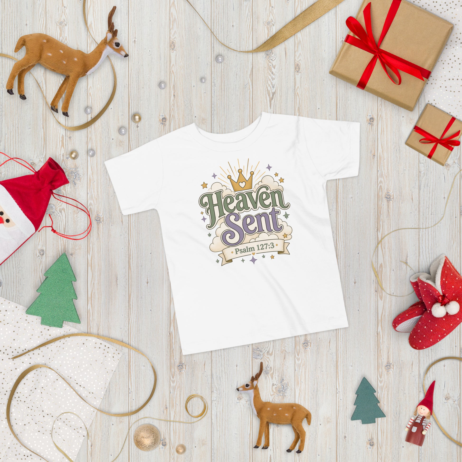 Christian toddler shirt design reading Heaven Sent with Psalm 127:3, featuring a crown, clouds, stars, and soft green, lavender, cream, and gold colors.