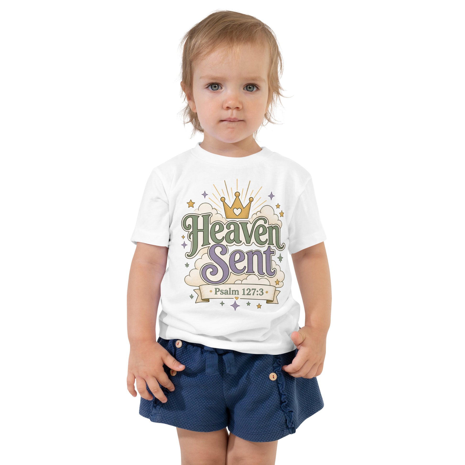Christian toddler shirt design reading Heaven Sent with Psalm 127:3, featuring a crown, clouds, stars, and soft green, lavender, cream, and gold colors.