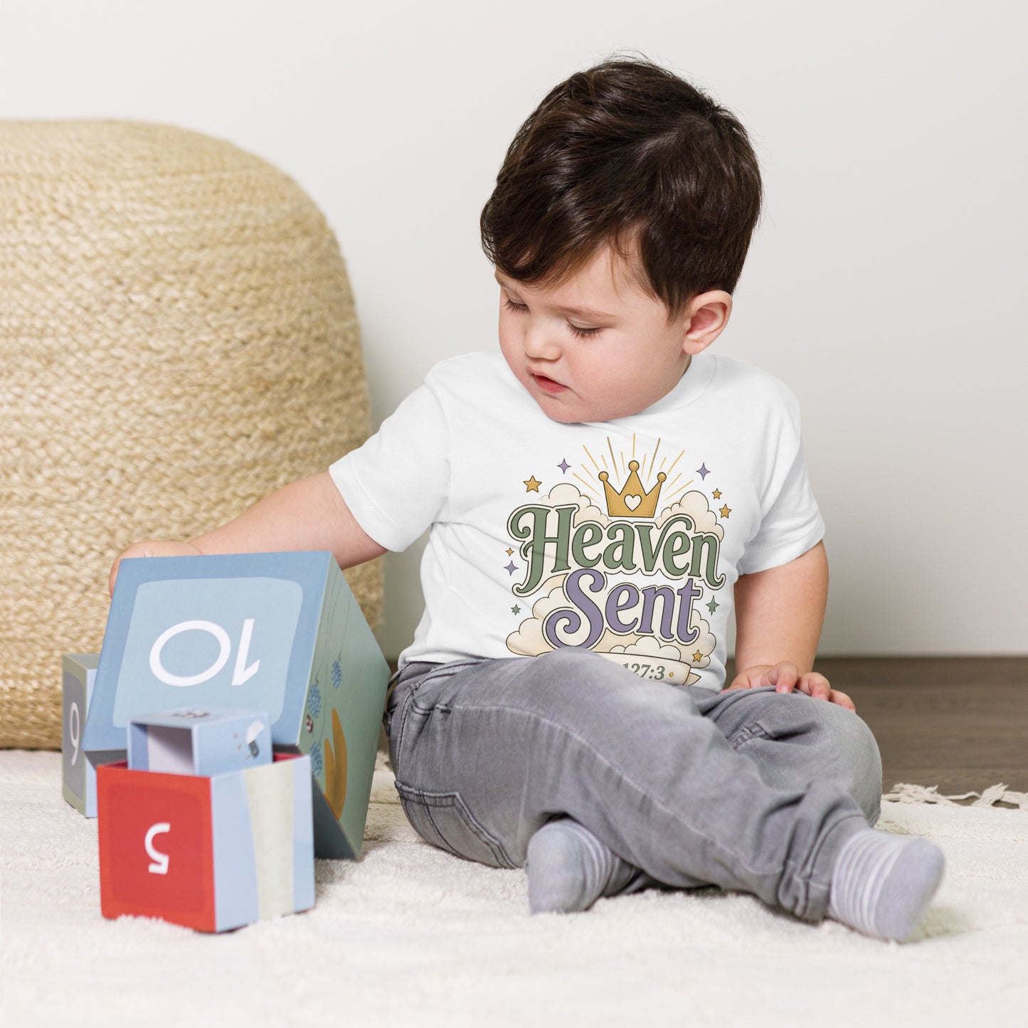 Christian toddler shirt design reading Heaven Sent with Psalm 127:3, featuring a crown, clouds, stars, and soft green, lavender, cream, and gold colors.