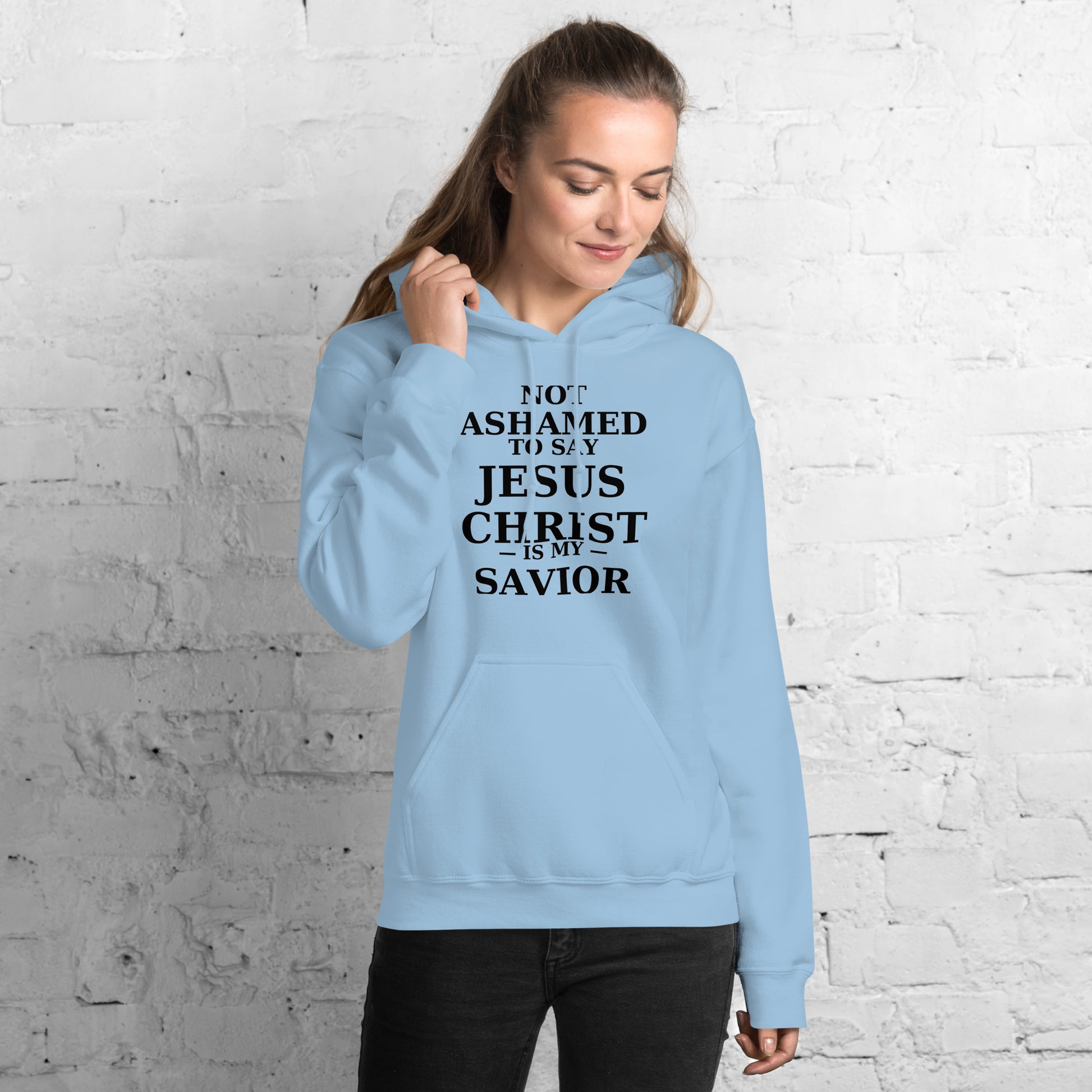 “Blue Christian hoodie with the bold faith message ‘Not Ashamed to Say Jesus Is My Savior’ in modern typography. Inspirational Scripture-based apparel for evangelism and everyday Christian streetwear.”