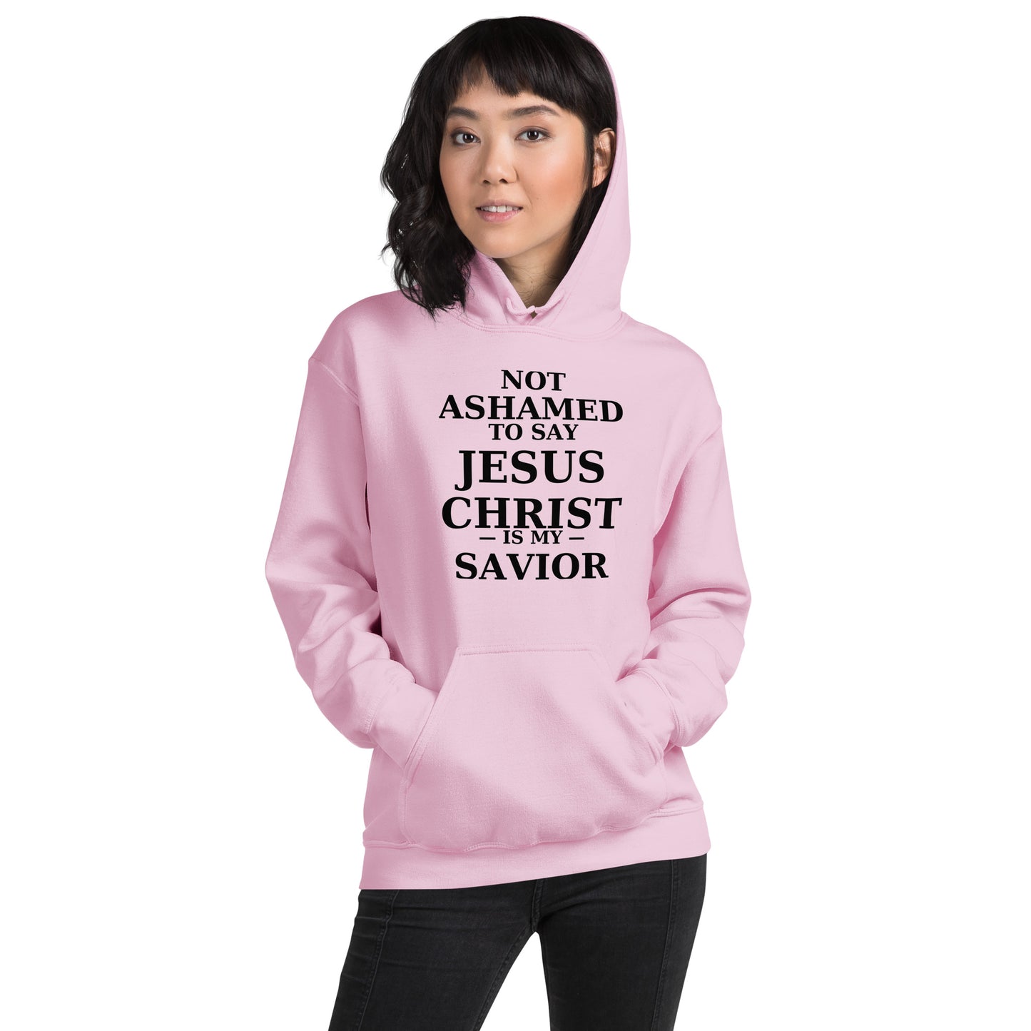 “Pink Christian hoodie with the bold faith message ‘Not Ashamed to Say Jesus Is My Savior’ in modern typography. Inspirational Scripture-based apparel for evangelism and everyday Christian streetwear.”