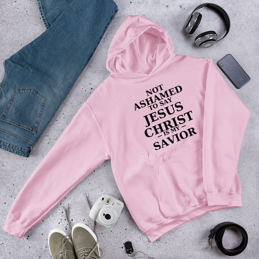 “Pink Christian hoodie with the bold faith message ‘Not Ashamed to Say Jesus Is My Savior’ in modern typography. Inspirational Scripture-based apparel for evangelism and everyday Christian streetwear.”