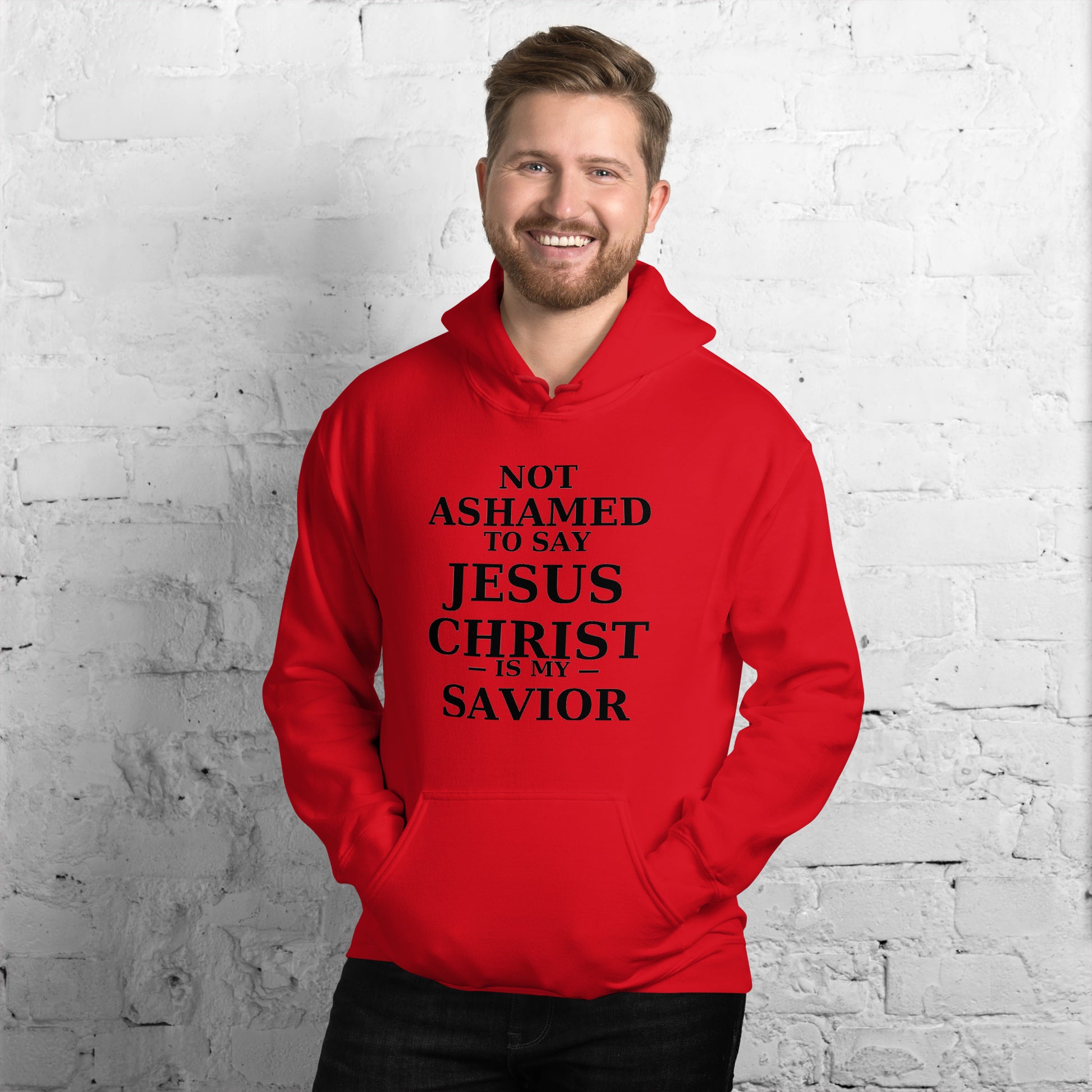 “Red Christian hoodie with the bold faith message ‘Not Ashamed to Say Jesus Is My Savior’ in modern typography. Inspirational Scripture-based apparel for evangelism and everyday Christian streetwear.”