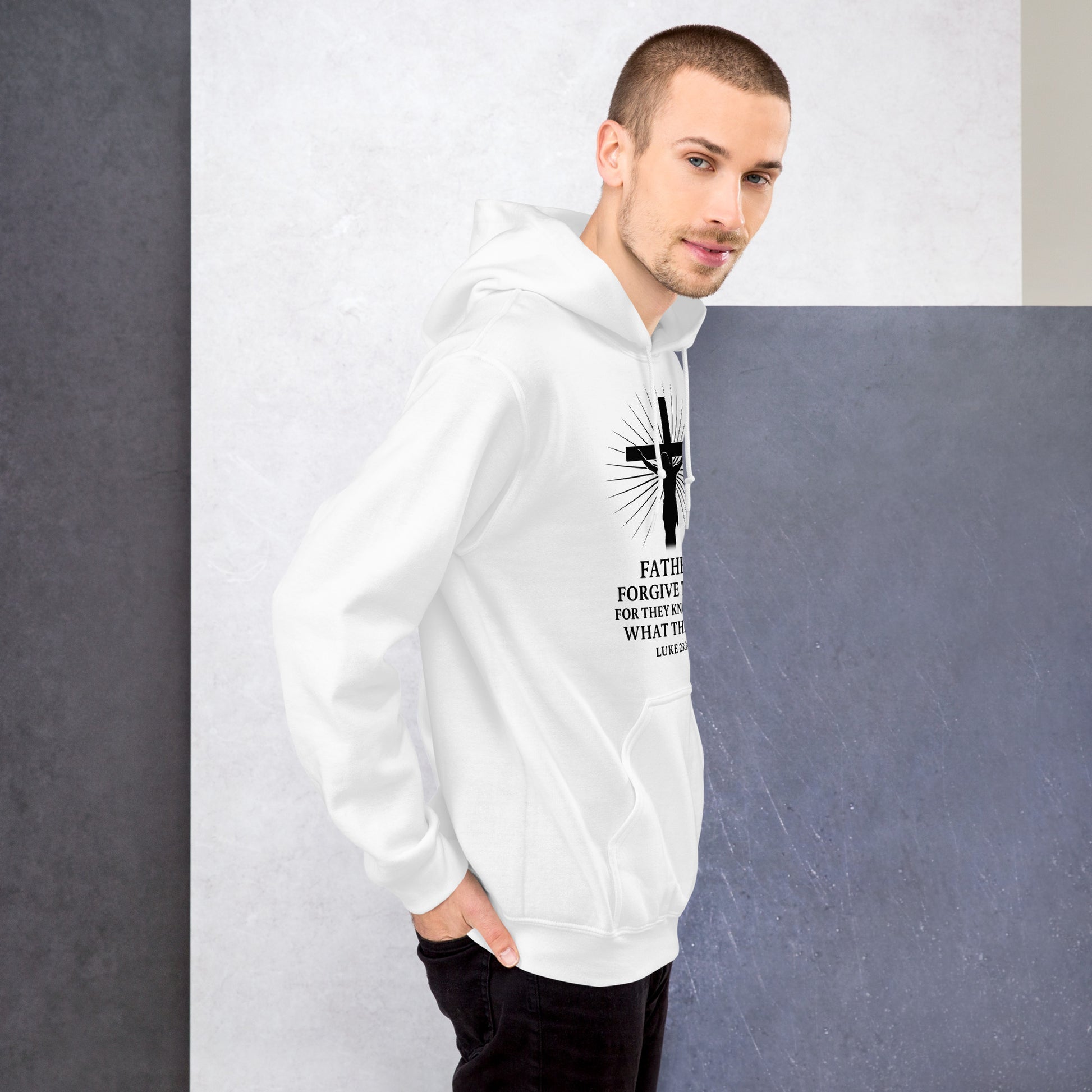 Man wearing a white hoodie with a black cross design and text against a gray background