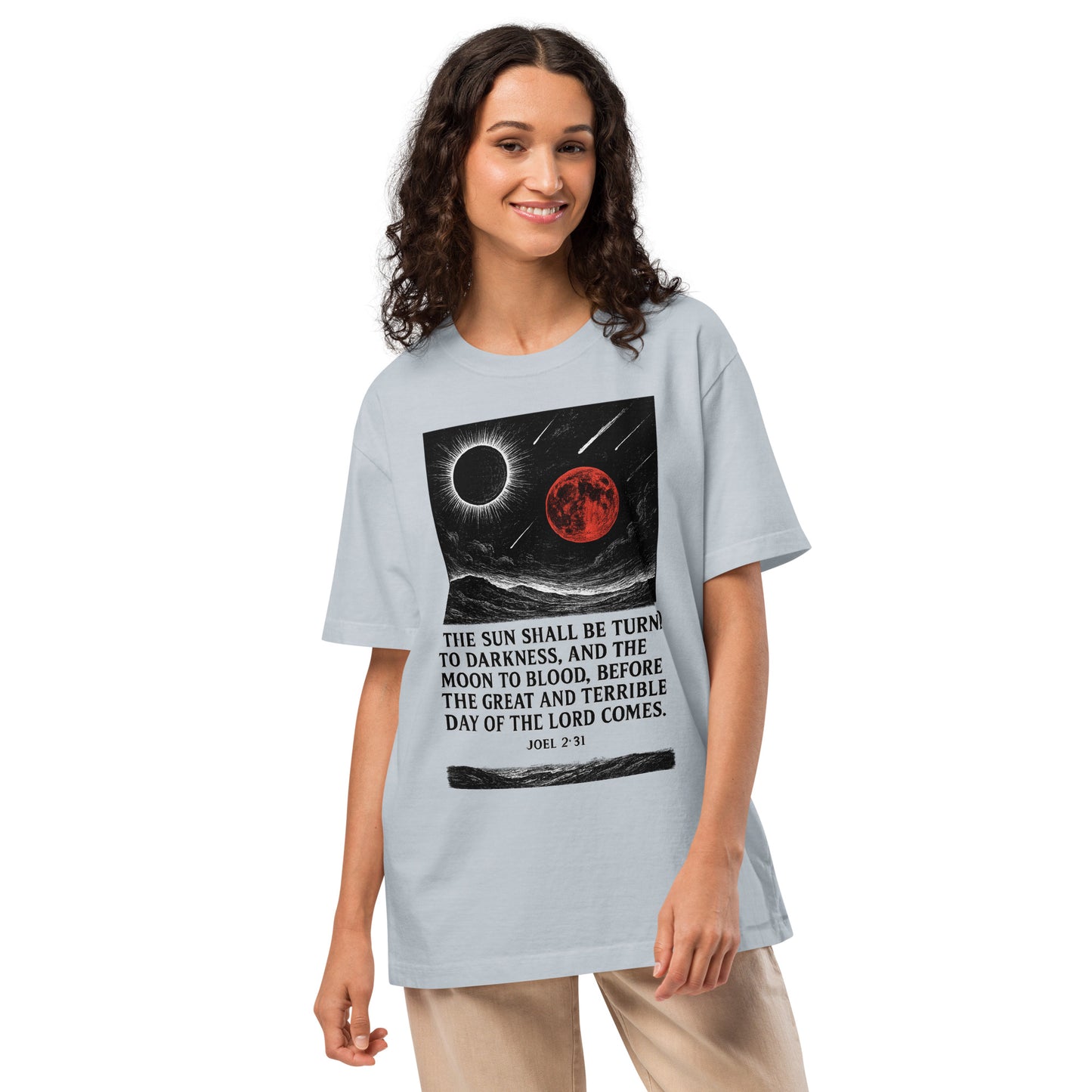 Woman wearing a light blue t-shirt with a graphic design and text on a white background