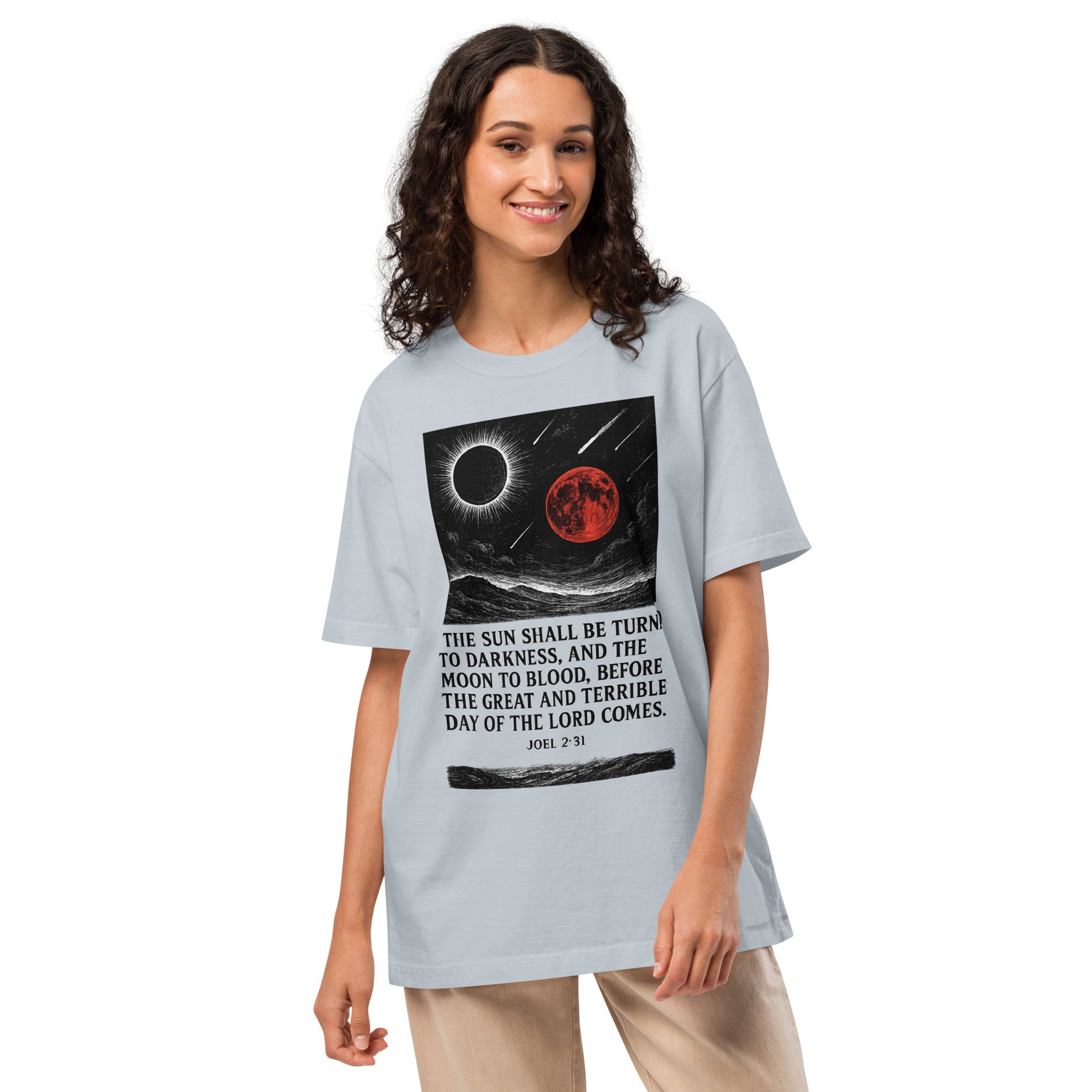 Woman wearing a light blue t-shirt with a graphic design and text on a white background