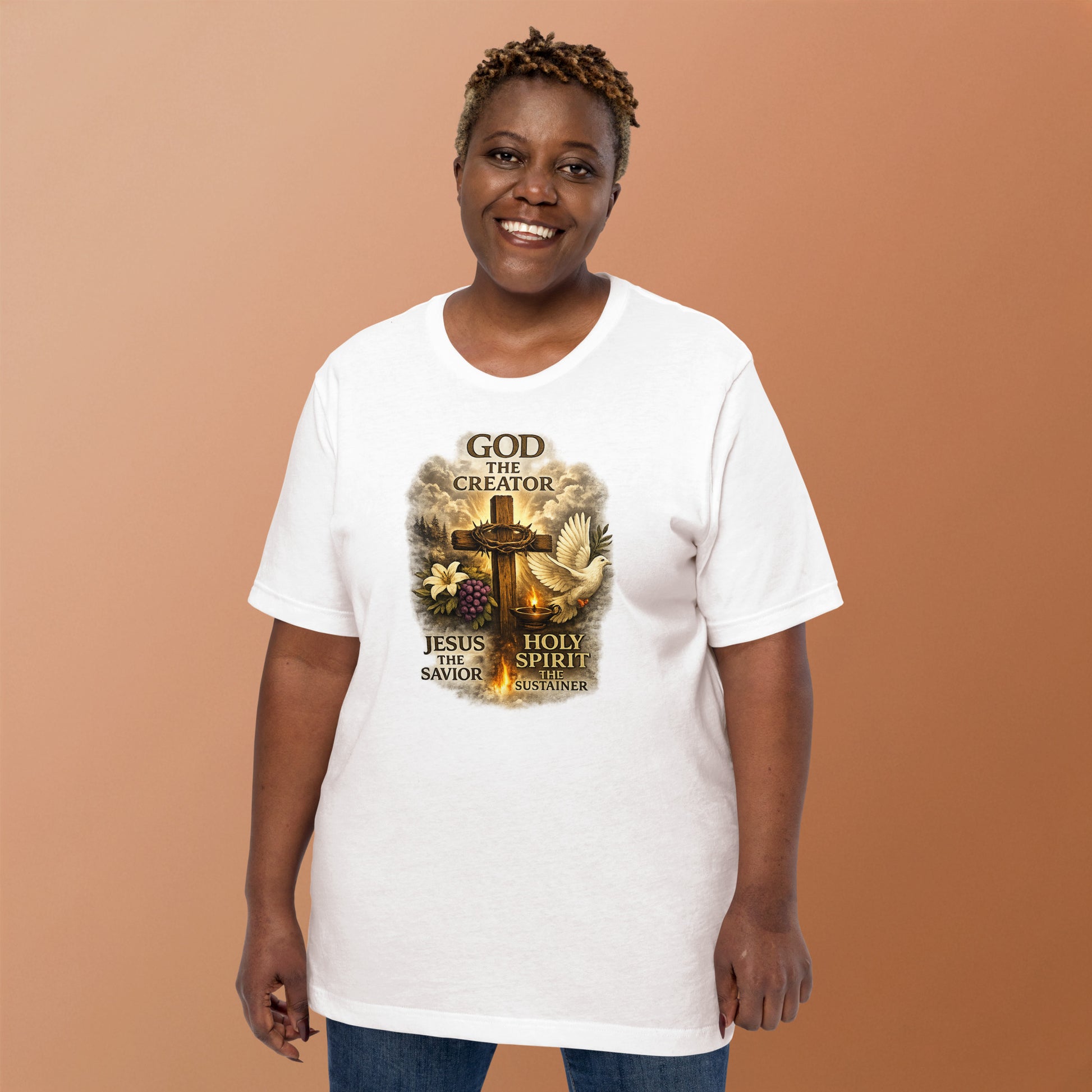 Christian white T-shirt design with the words God the Creator Jesus the Savior Holy Spirit the Sustainer featuring a wooden cross, dove, flame, grapes, and lily