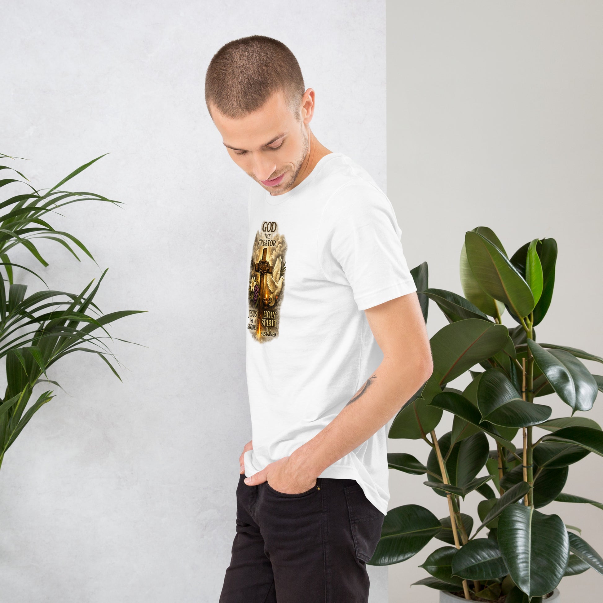 Christian white T-shirt design with the words God the Creator Jesus the Savior Holy Spirit the Sustainer featuring a wooden cross, dove, flame, grapes, and lily